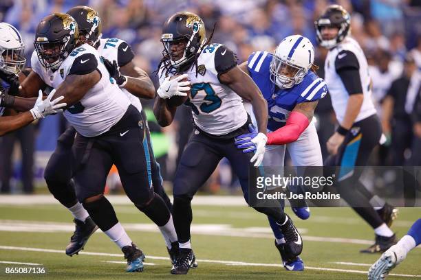 Chris Ivory of the Jacksonville Jaguars runs with the ball chased by Jabaal Sheard of the Indianapolis Colts during the first quarter at Lucas Oil...