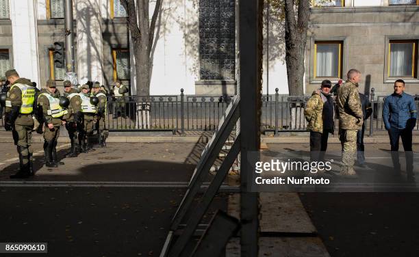 Protesters and policemen stand separated with a fence in Kyiv, Ukraine, Oct.22, 2017. Dozens Ukrainians set up a tent camp in front of Parliament...