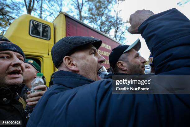 Protesters shout slogans as they confront with the police which block the vehicle with sound-amplifying facilities in Kyiv, Ukraine, Oct.22, 2017....