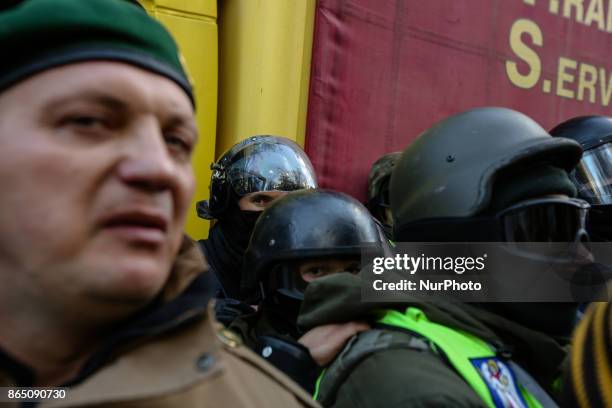 Protesters confront with the police which block the vehicle with sound-amplifying facilities in Kyiv, Ukraine, Oct.22, 2017. Dozens Ukrainians set up...