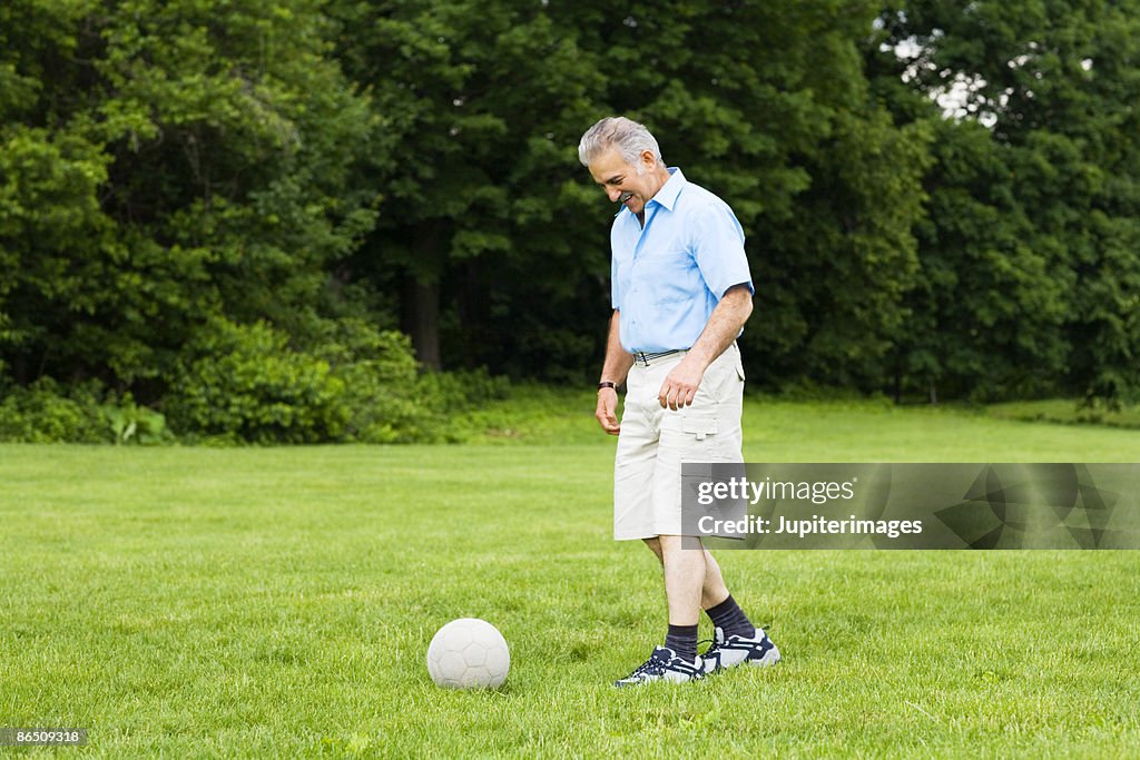 Man kicking soccer ball