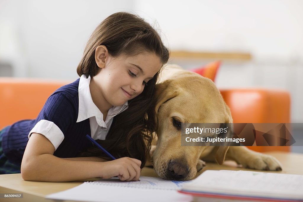 Girl with dog and homework