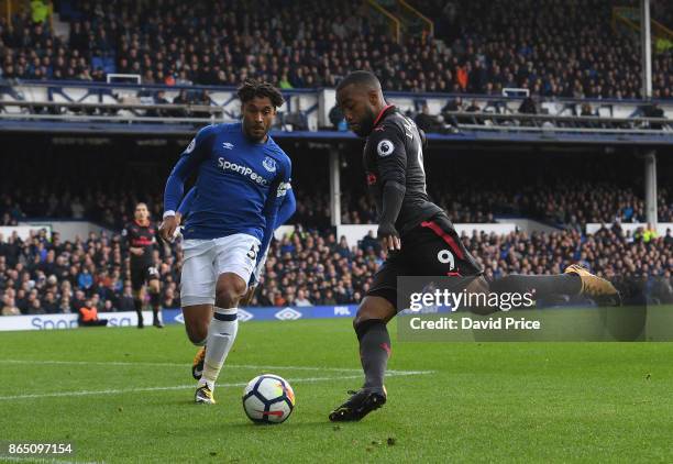 Alexlexandre Lacazette of Arsenal shoots under pressure from Ashley Williams of Everton during the Premier League match between Everton and Arsenal...