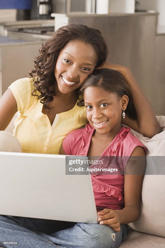 Mother and daughter with a laptop computer