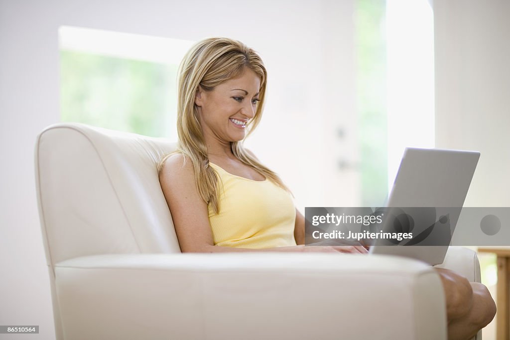 Smiling woman with laptop computer