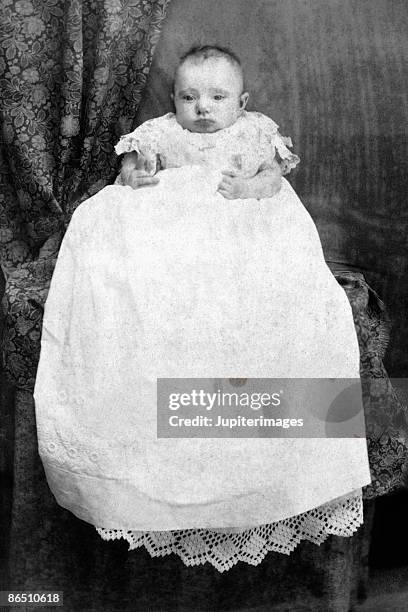 vintage image of infant in christening gown - christening gown stockfoto's en -beelden