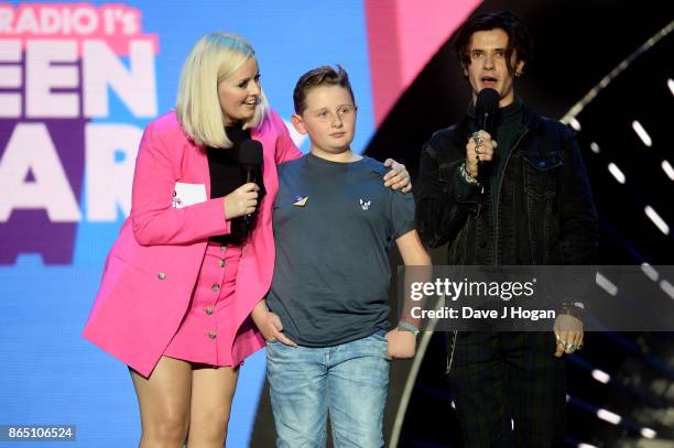 Harrison Wright is presented with the Teen Hero award on stage by Katie Thistleton and Cel Spellman at the BBC Radio 1 Teen Awards 2017 at Wembley...