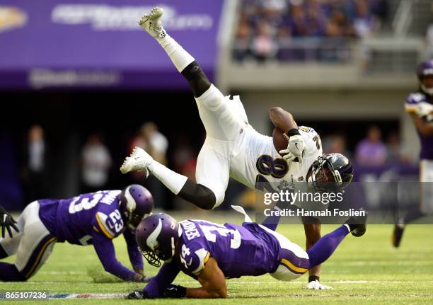 Benjamin Watson of the Baltimore Ravens is upended by Andrew Sendejo of the Minnesota Vikings in the second quarter of the game on October 22, 2017...