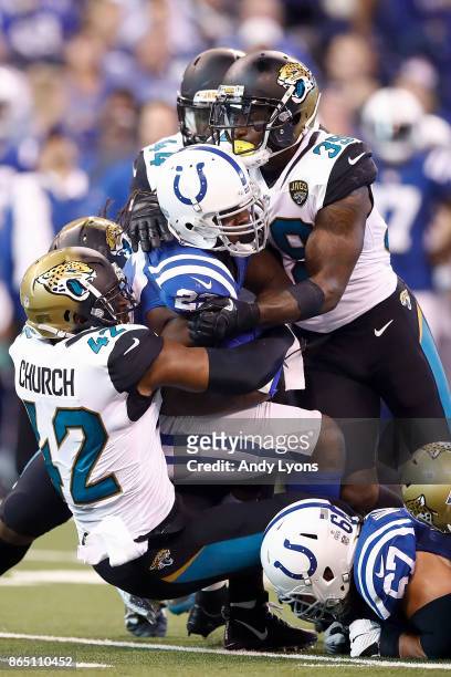 Barry Church and Tashaun Gipson of the Jacksonville Jaguars stop a run by Frank Gore of the Indianapolis Colts during the first half at Lucas Oil...