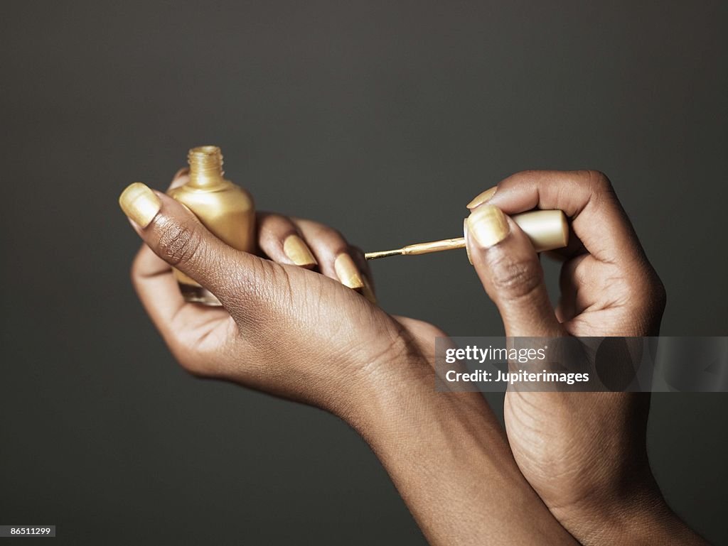 Woman with gold nail polish