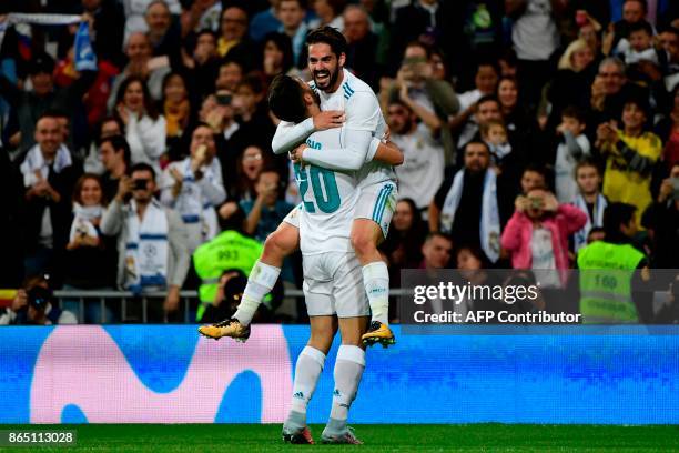 Real Madrid's Spanish midfielder Marco Asensio celebrates with Real Madrid's Spanish midfielder Isco after scoring a goal during the Spanish league...