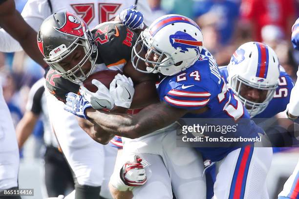 Doug Martin of the Tampa Bay Buccaneers is tackled by Leonard Johnson of the Buffalo Bills during the second quarter of of an NFL game on October 22,...