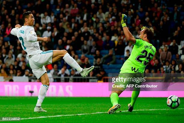 Real Madrid's Portuguese forward Cristiano Ronaldo tries to score past Eibar's Serbian goalkeeper Marko Dmitrovic during the Spanish league football...