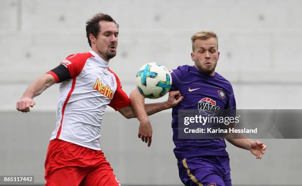 Pascal Koepke of Aue challenges Sebastian Nachreiner of Regensburg during the Second Bundesliga match between FC Erzgebirge Aue and SSV Jahn...