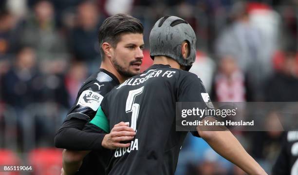 Stefan Kleineheismann talks to Klaus Gjasula of Halle during the 3.Liga match between FC Rot-Weiss Erfurt and Hallescher FC at Arena Erfurt on...