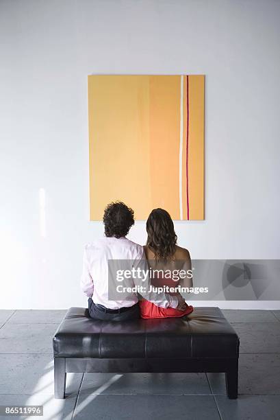 couple looking at painting - couple art gallery stock pictures, royalty-free photos & images