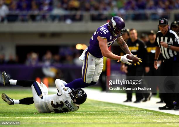 Eric Weddle of the Baltimore Ravens tackles Kyle Rudolph of the Minnesota Vikings with the ball in the first half of the game on October 22, 2017 at...