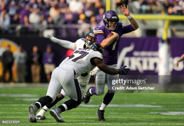 Case Keenum of the Minnesota Vikings runs with the ball while being pursued by defenders C.J. Mosley and Za'Darius Smith of the Baltimore Ravens in...