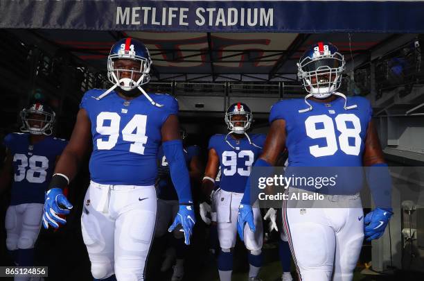 Dalvin Tomlinson, B.J. Goodson and Damon Harrison of the New York Giants walk out of the tunnel for warm-ups before taking on the Seattle Seahawks at...