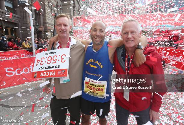 Ben Kaplan poses with Ed Whitlock's sons, Clive and Neil after running the race at the pace of Whitlock's world record he set at 85 years of age...