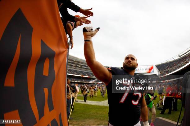 Kyle Long of the Chicago Bears high fives fans after the Bears defeated the Carolina Panthers 17-3 at Soldier Field on October 22, 2017 in Chicago,...