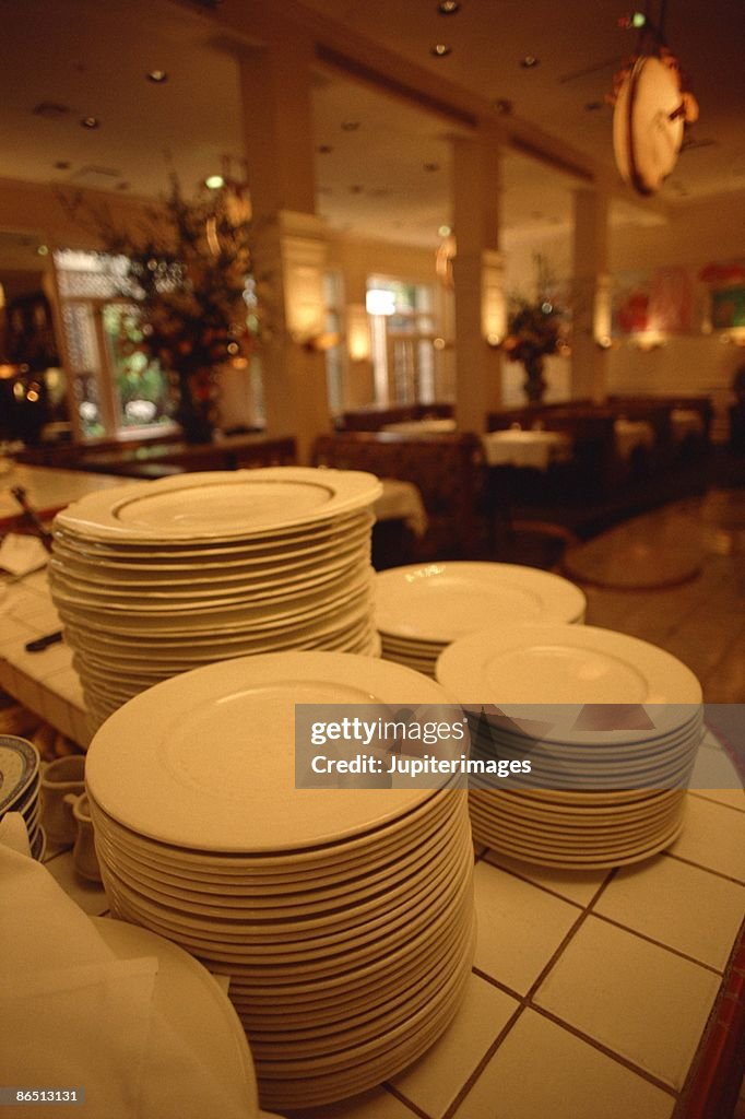 Stacks of clean plates in restaurant