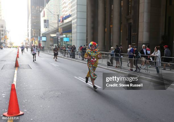 Petro Czupiel ran the half-marathon in 1:30 dressed as a clown during the Scotiabank Toronto Waterfront Marathon in Toronto. October 22, 2017.