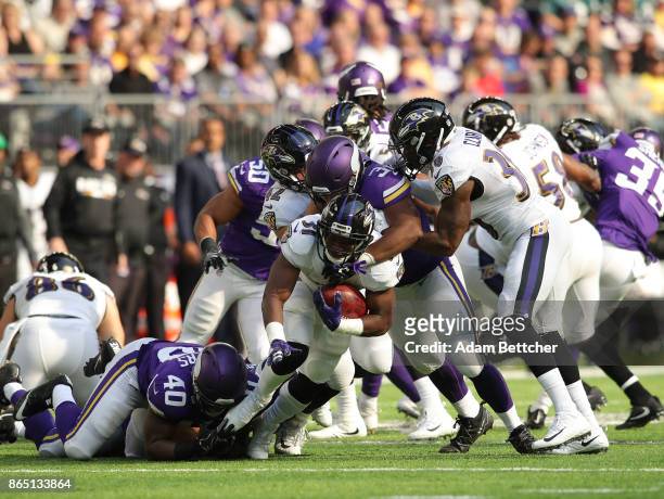 Bobby Rainey of the Baltimore Ravens is tackled with the ball in the second half of the game against the Minnesota Vikings on October 22, 2017 at...