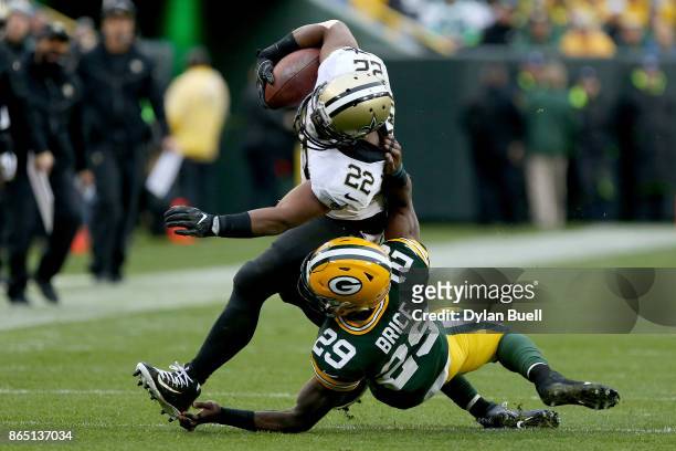 Kentrell Brice of the Green Bay Packers commits a horse-collar penalty against Mark Ingram of the New Orleans Saints in the fourth quarter at Lambeau...