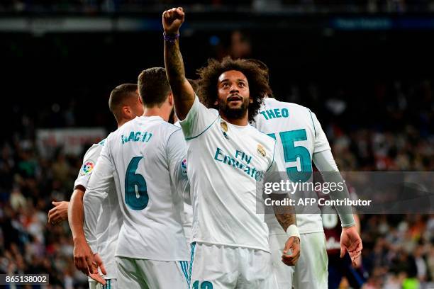 Real Madrid's Brazilian defender Marcelo celebrates after scoring his team's third goal during the Spanish league football match Real Madrid CF vs SD...