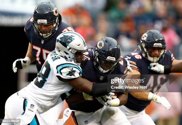 Jordan Howard of the Chicago Bears is tackled by Thomas Davis of the Carolina Panthers in the second half at Soldier Field on October 22, 2017 in...