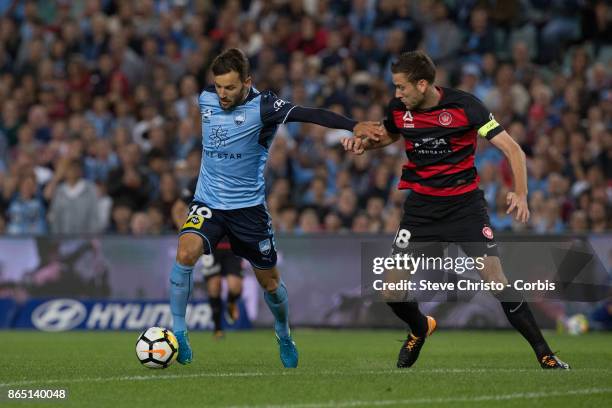 Milos Ninkovic of Sydney FC is challenged for the ball by Wanderers captain Robert Cornthwaite during the round three A-League match between Sydney...