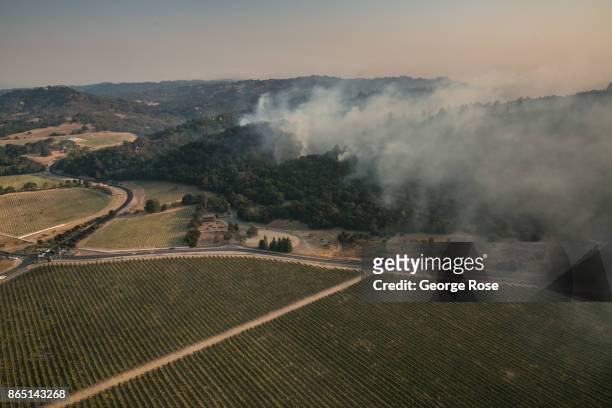 Fire continues to burn in the hillside in the Chalk Hill wine region of the county as viewed in this aerial photo taken on October 11 in Santa Rosa,...