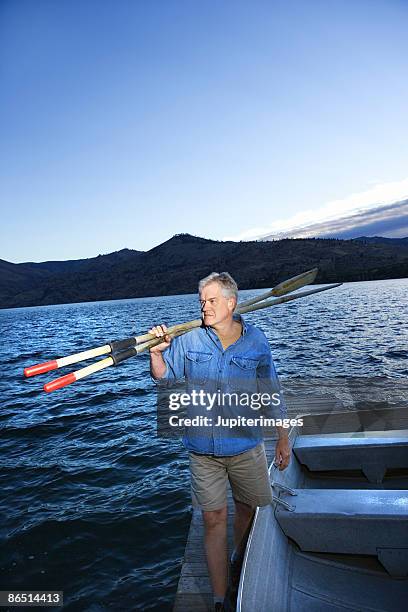 man carrying oars, lake chelan, washington - lake chelan stock-fotos und bilder