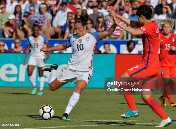 Carli Lloyd of USA takes a shot against Lee Eunmi of Korea Republic during their game at WakeMed Soccer Park on October 22, 2017 in Cary, North...