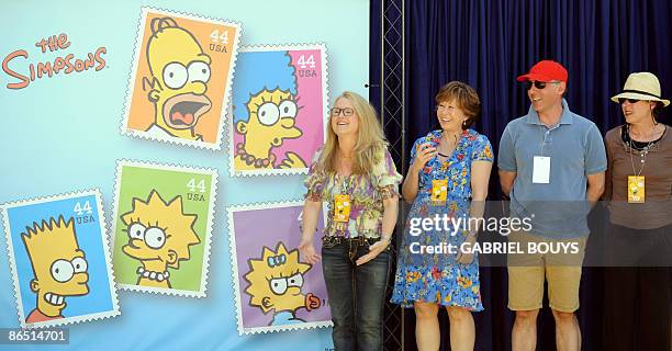 Actors Nancy Cartwright , Yeardley Smith , Dan Castellaneta and Julie Kavner pose close to the unveiled stamps of the Simpsons characters at the Fox...