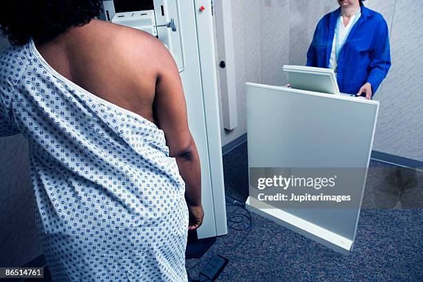 woman getting mammogram - mammogram stock pictures, royalty-free photos & images