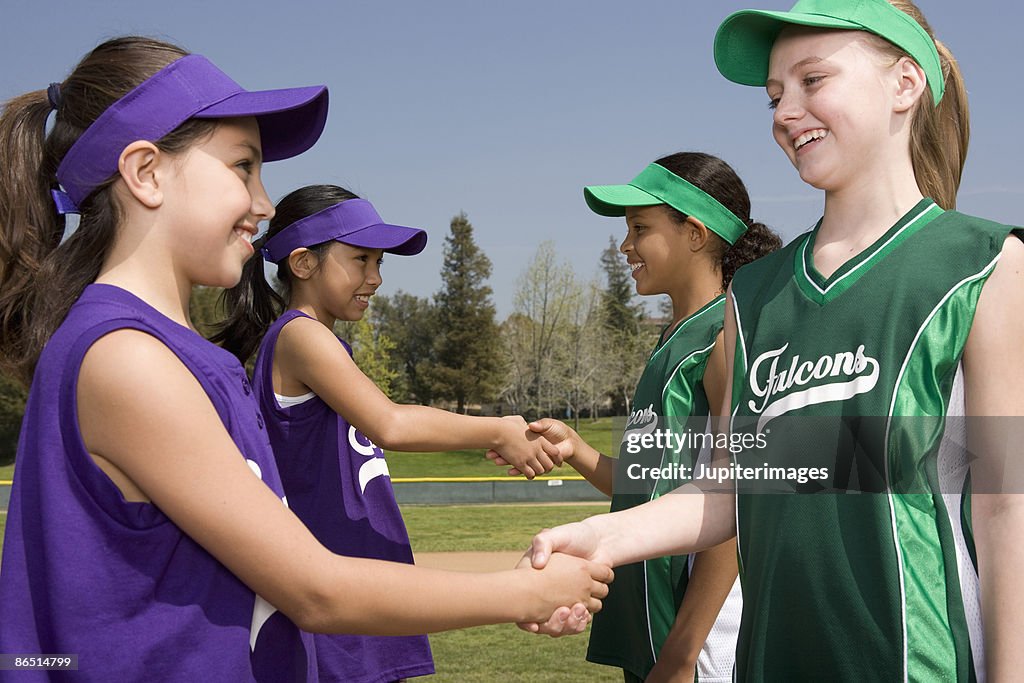 Little league opponents shaking hands