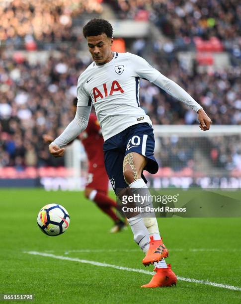 Dele Alli of Tottenham Hotspur runs with the ball during the Premier League match between Tottenham Hotspur and Liverpool at Wembley Stadium on...