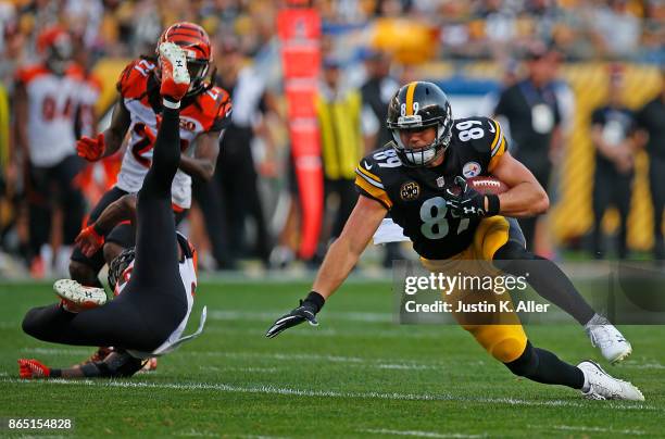 Vance McDonald of the Pittsburgh Steelers falls to the ground after a reception in the first half during the game against the Cincinnati Bengals at...