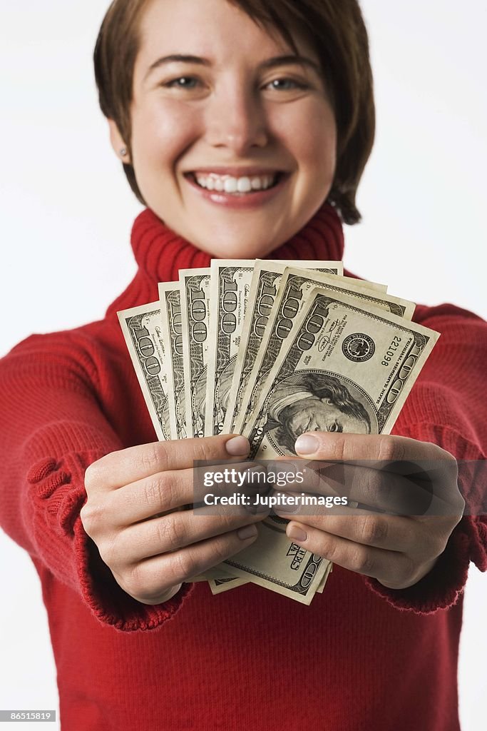 Happy woman holding money