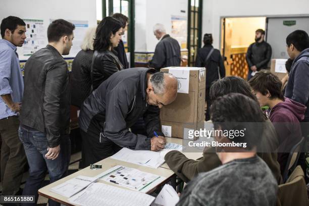 Voter registers to cast a ballot at a polling station in Buenos Aires, Argentina, on Sunday, Oct. 22, 2017. Argentines will have the opportunity to...