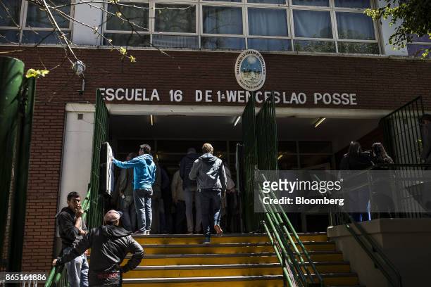 Voters check registration lists outside of a polling station in Buenos Aires, Argentina, on Sunday, Oct. 22, 2017. Argentines will have the...