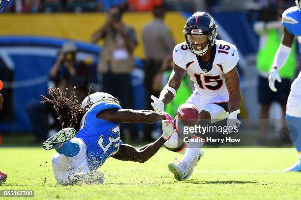 Hunter Sharp of the Denver Broncos and Jahleel Addae of the Los Angeles Chargers make an attempt for a deflected ball in the second quarter at the...