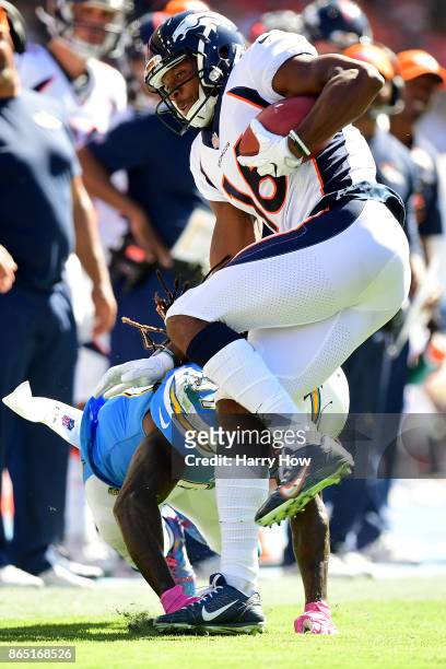 Bennie Fowler of the Denver Broncos is tripped up by Jahleel Addae of the Los Angeles Chargers during the second quarter of the game at the StubHub...