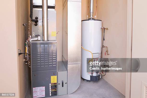 hot water heater and furnace in basement - basement stock pictures, royalty-free photos & images