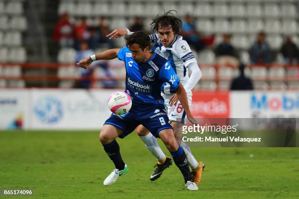 Jose Martinez of Pachuca fights for the ball with Francisco Acuna of Puebla during the 14th round match between Pachuca and Puebla as part of the...