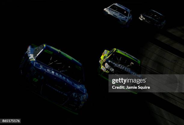Jimmie Johnson, driver of the Lowe's Chevrolet, leads a pack of cars during the Monster Energy NASCAR Cup Series Hollywood Casino 400 at Kansas...