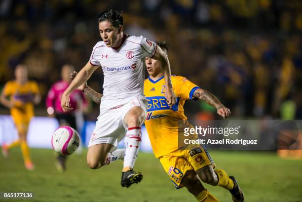 Efrain Velarde of Toluca fights for the ball with Eduardo Vargas of Tigres during the 14th round match between Tigres UANL and Toluca as part of the...