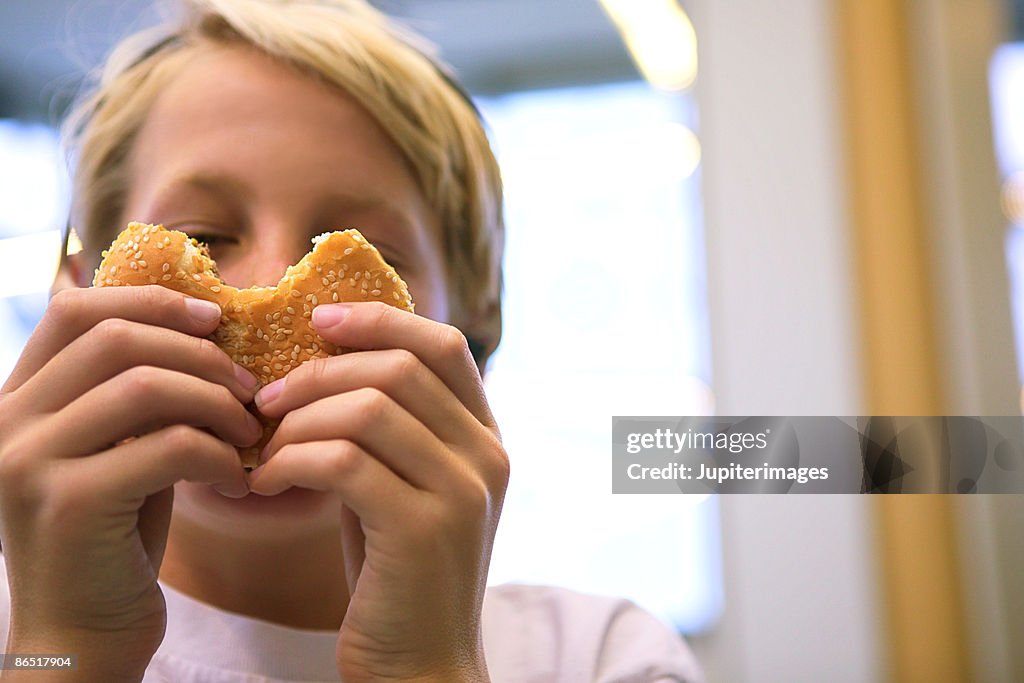 Boy eating hamburger